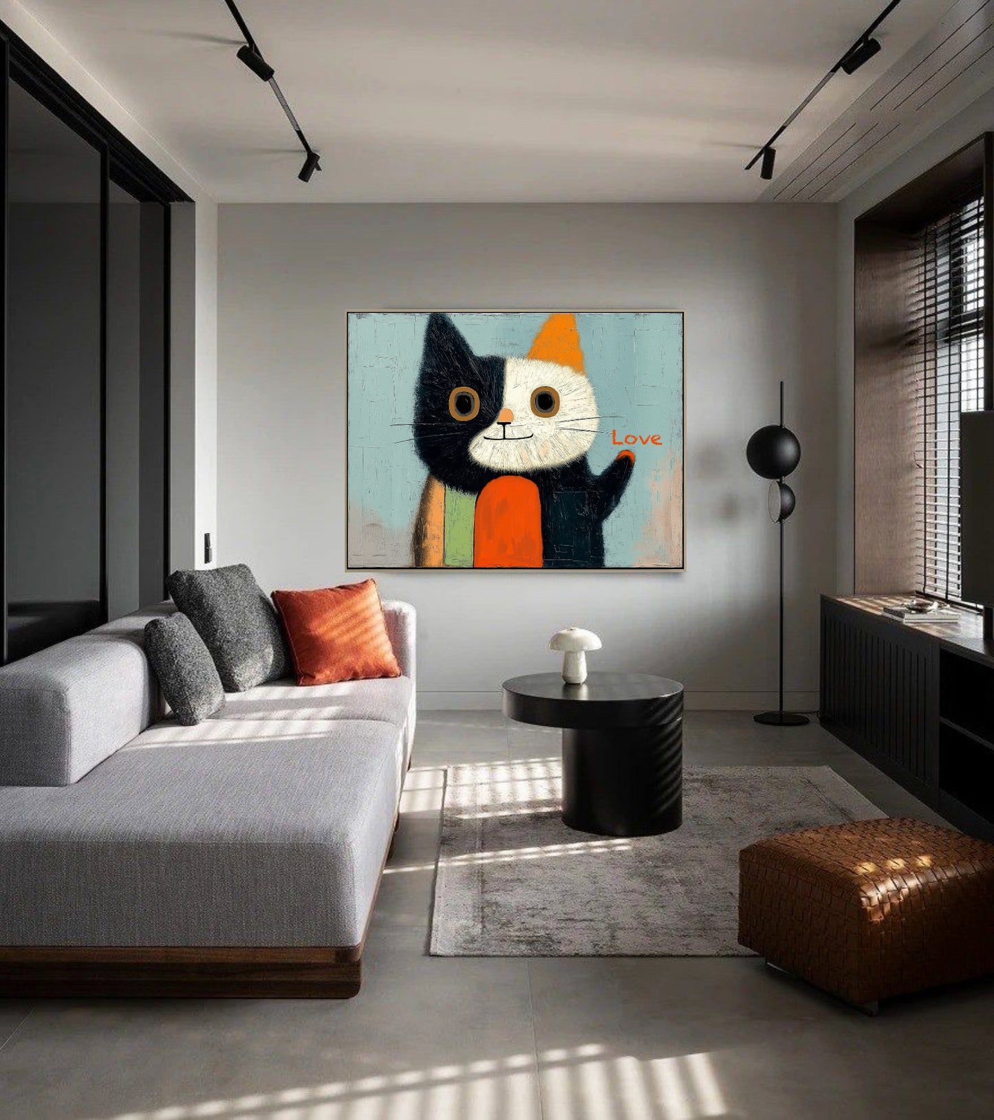 Original cat artwork above a light grey sectional couch; modern, sunny interior with striking track lighting and geometric decor.
