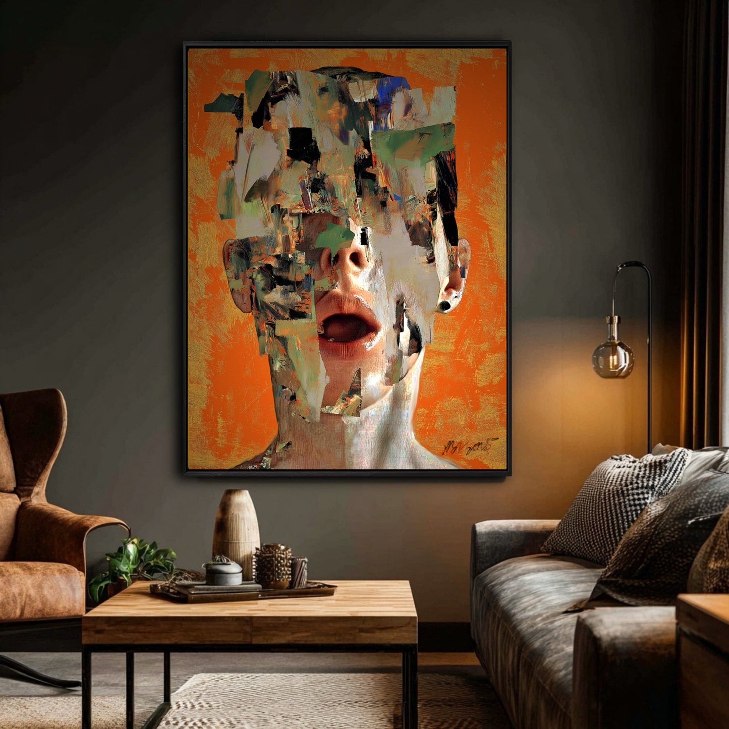 A bright orange abstract painting adds a pop of color to a dark, moody living room, hanging near a brown leather chair and sofa.