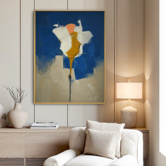 Textured abstract art in a quiet reading corner. The painting's sophisticated blue and gold hues create a focal point by the lamp.