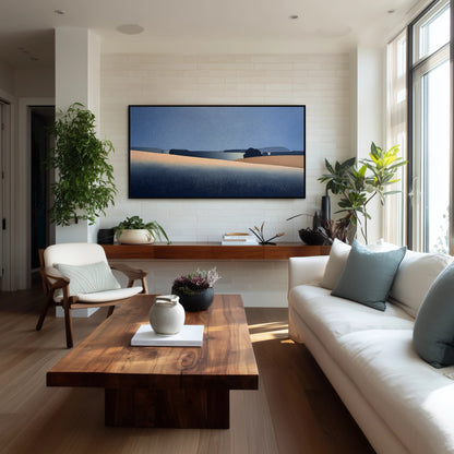 Abstract horizon painting centered on a textured white wall, complementing a warm wood coffee table and lush indoor plants.