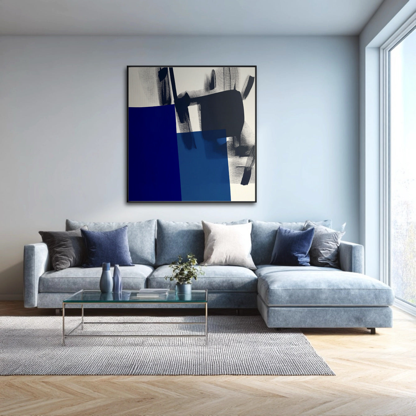 Abstract blue and black art complements a soft, powder blue sectional and glass table in a bright, minimalist living room with large windows.
