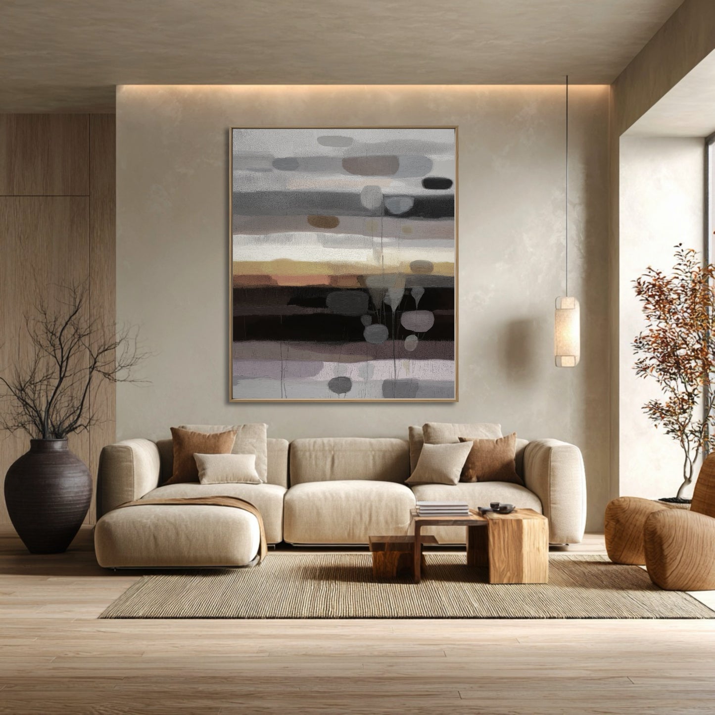 Abstract neutral horizon art above a large sectional complements the earth tones and rustic wood accents in this cozy living room.