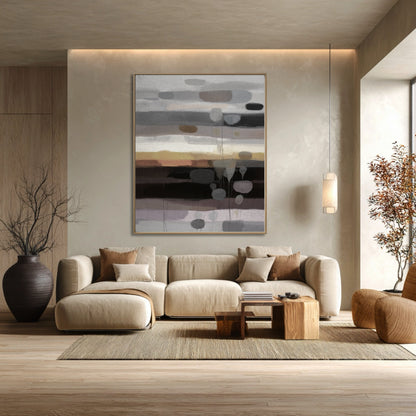 Abstract neutral horizon art above a large sectional complements the earth tones and rustic wood accents in this cozy living room.