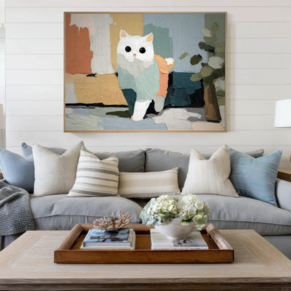 Horizontal abstract cat art centers a coastal cottage living room with shiplap walls, a gray linen sofa, and a light wood coffee table for a relaxed vibe.