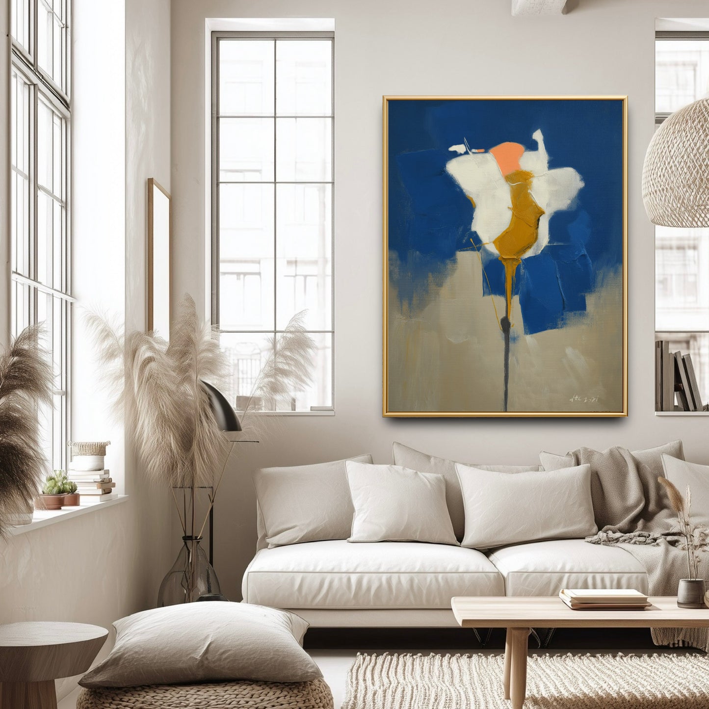 Modern blue and white painting in a bright living room. The vibrant art adds bold depth to the minimalist white furniture.