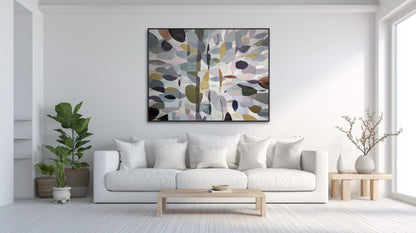 Large original canvas centers a bright, minimalist living room, grounding the clean white aesthetic with subtle, organic color and form.