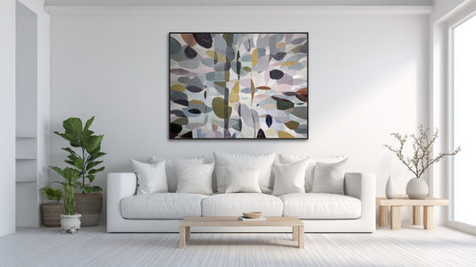 Large original canvas centers a bright, minimalist living room, grounding the clean white aesthetic with subtle, organic color and form.