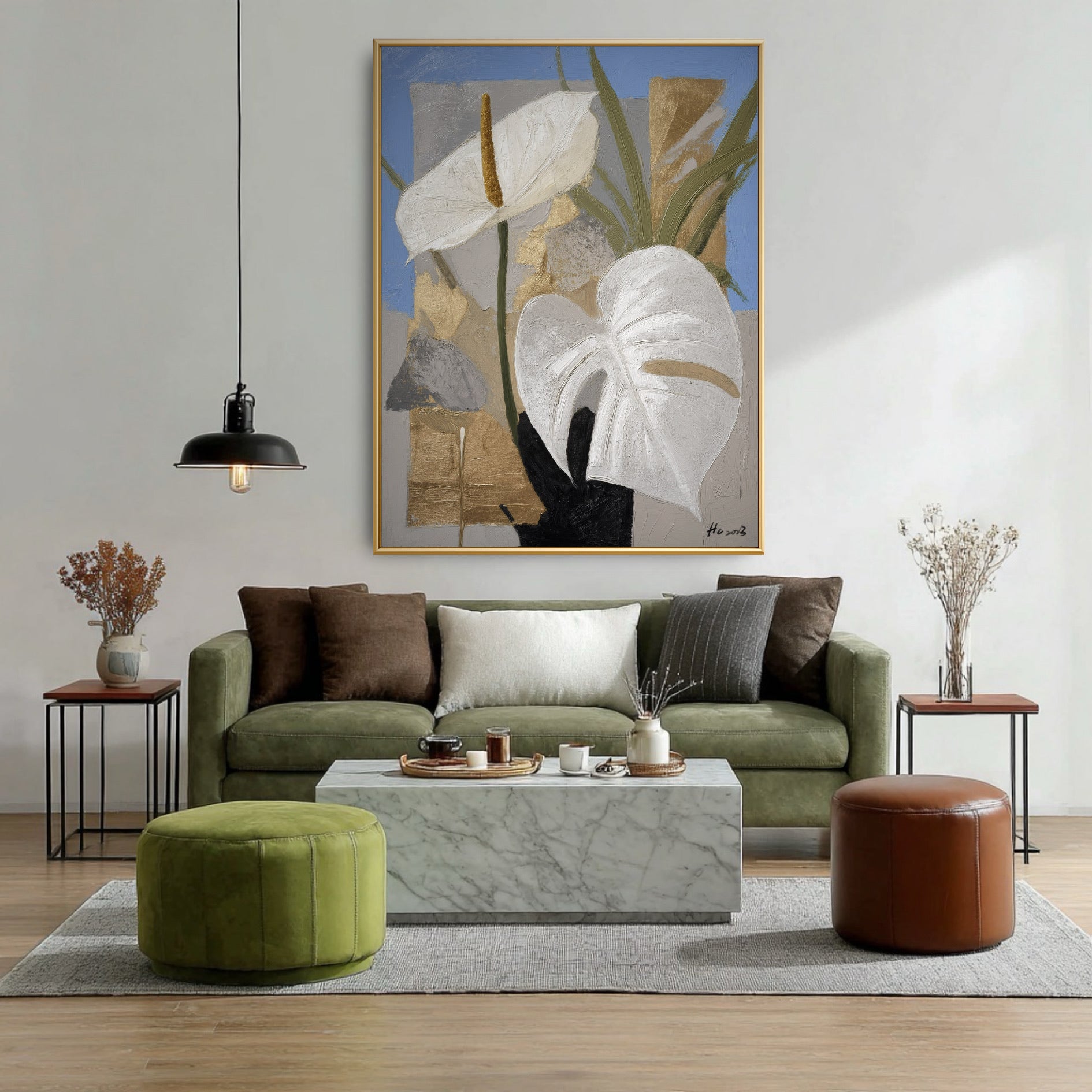 Original vertical botanical painting above green sofa. White floral art on blue background matching organic living room decor.