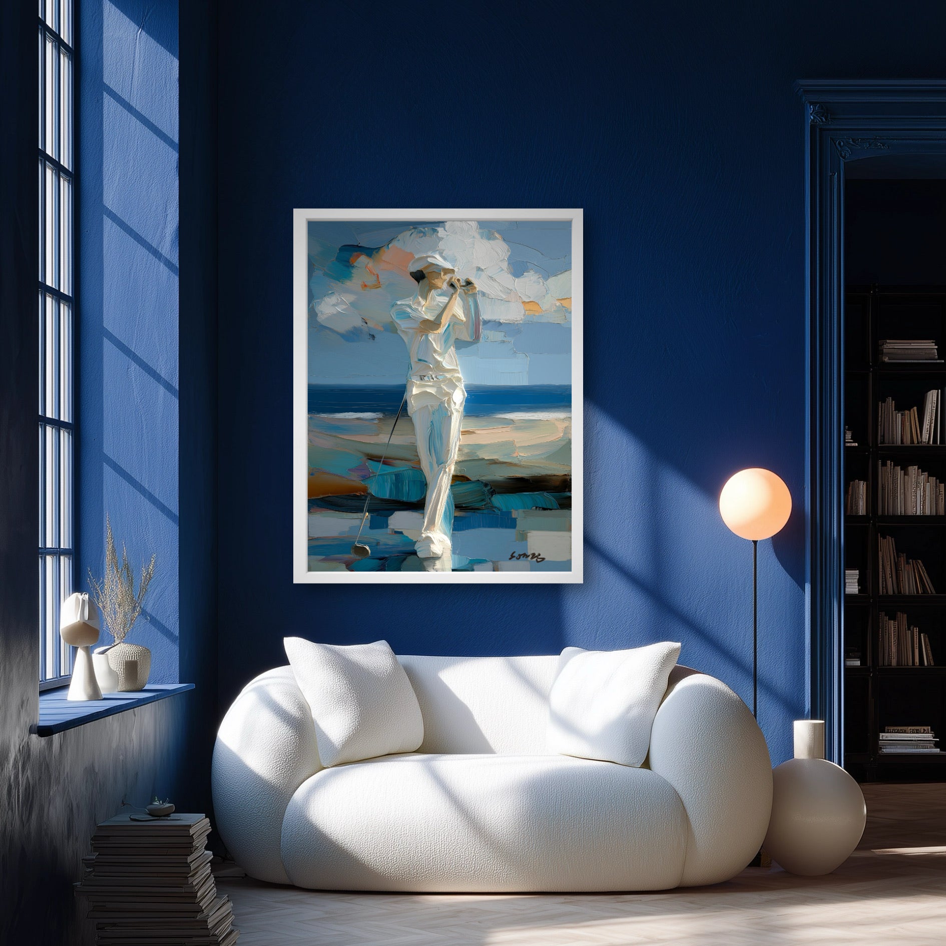 Coastal golf painting in blue living room. White texture pops against deep blue walls and white sofa for a relaxing vibe.