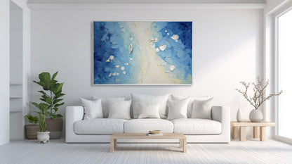 Original blue and white impasto art providing a refreshing color aura against a stark white wall in a bright, minimalist living space.