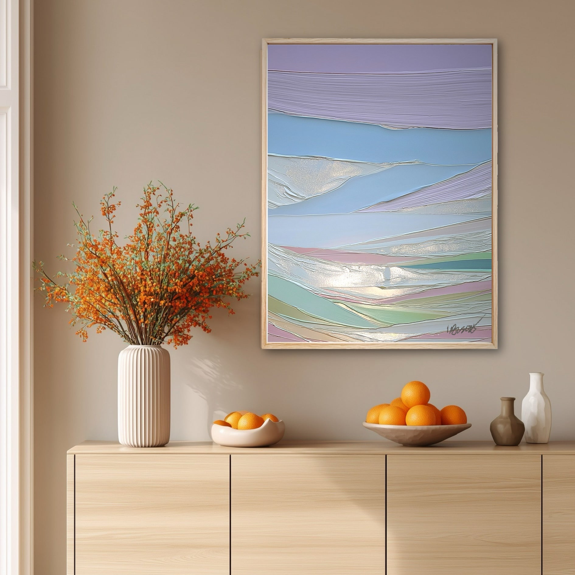 The abstract painting's cool pastel colors create a soft contrast with the warm orange berries and wood console table beneath it.