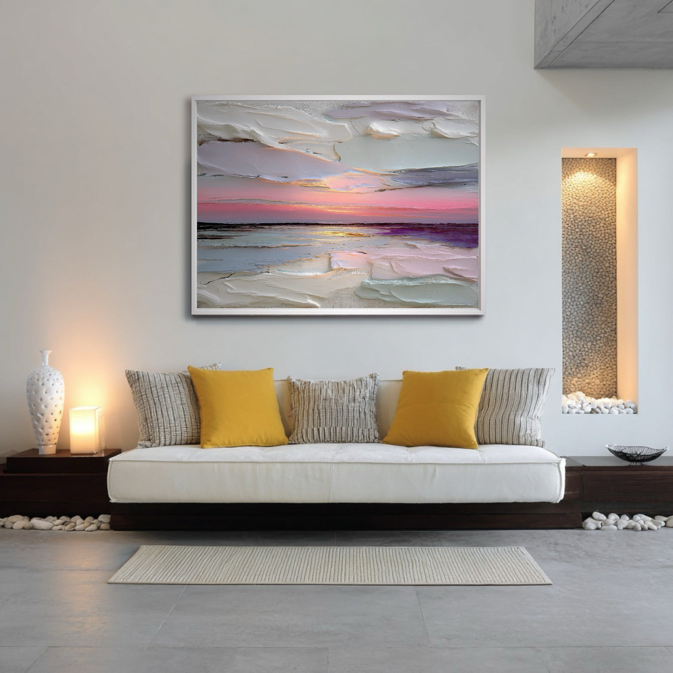 Abstract sunset art centers a minimalist daybed, blending with the low profile furniture, ambient lighting, and decorative river rock accents.