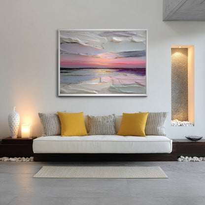 Abstract sunset art centers a minimalist daybed, blending with the low profile furniture, ambient lighting, and decorative river rock accents.