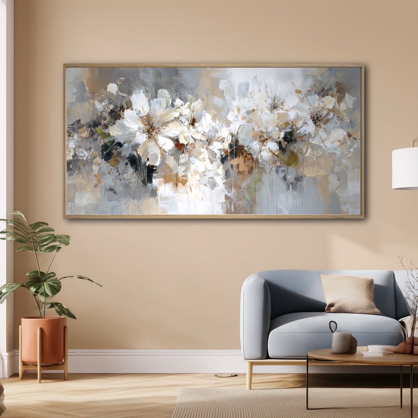 Abstract floral art with warm neutral tones complements the beige wall, creating a cozy focal point above a modern blue-grey sofa.