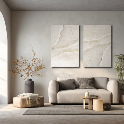Textured neutral art enhancing a muted, minimalist living area with soft light and a graceful arched doorway.