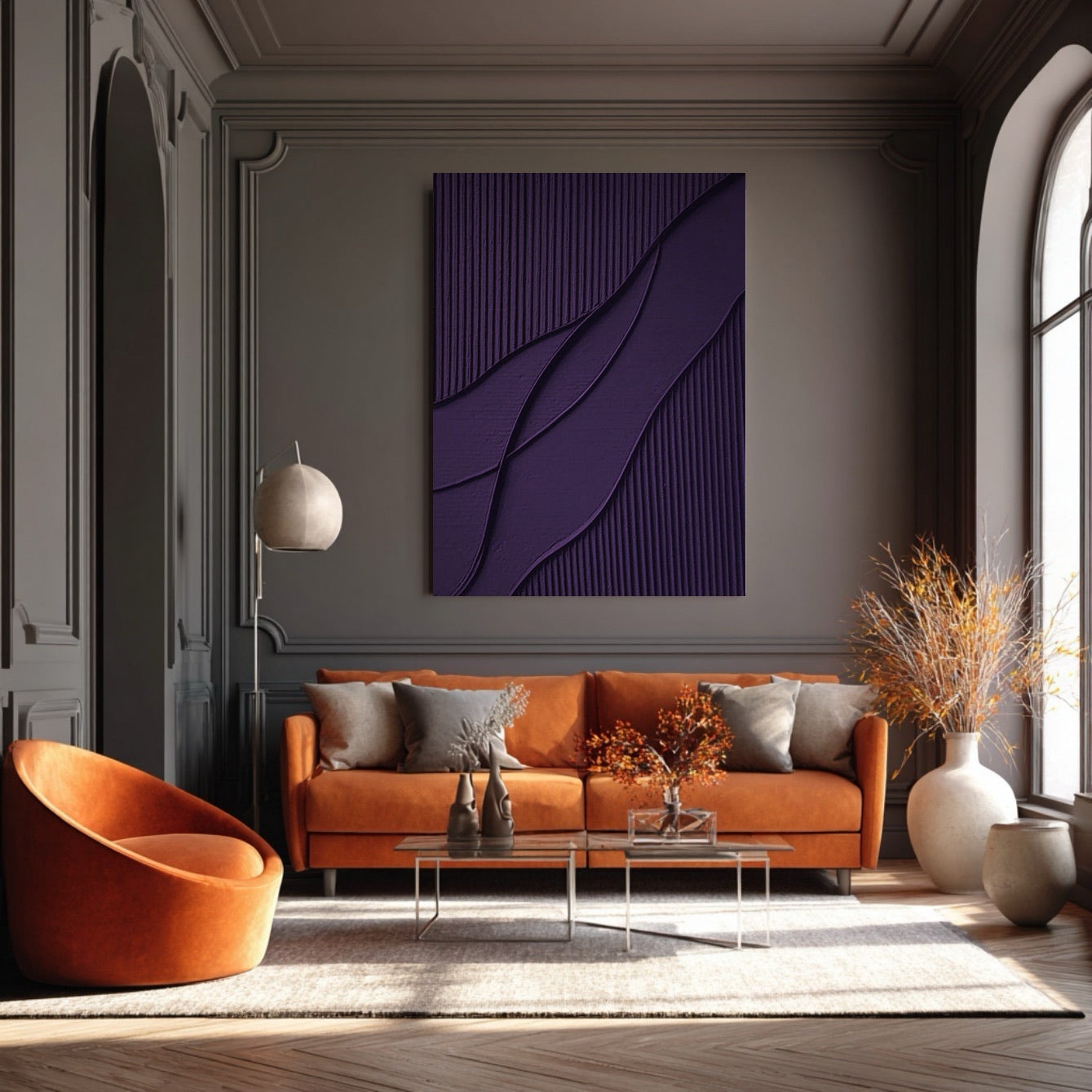 Abstract textured art dramatically contrasting an orange sofa and dark grey wainscoting. Bold color and classic arch mix.