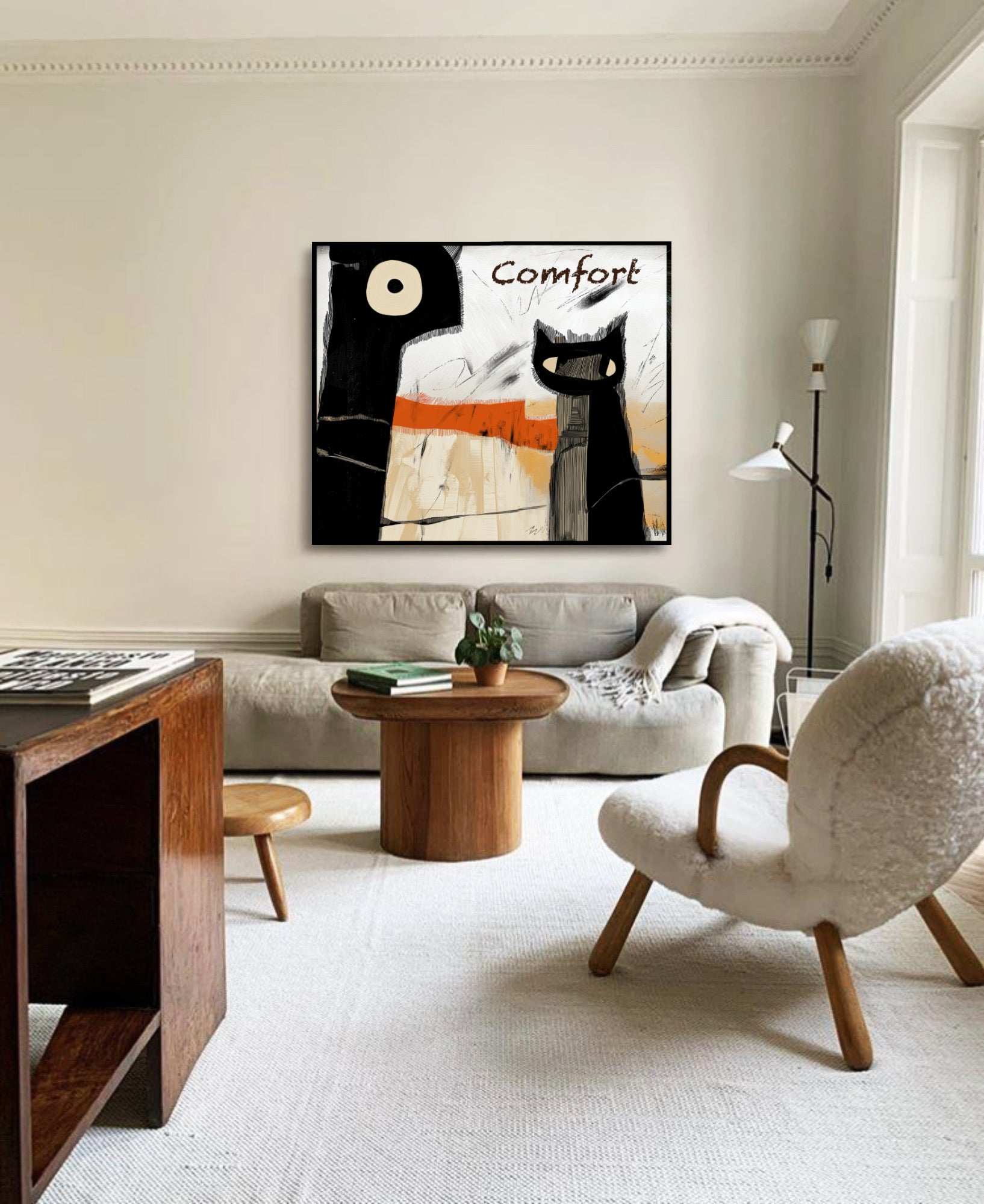 Abstract "Comfort" art anchors a bright, minimalist living room; its black contrast balances the neutral sofa and organic wood decor.