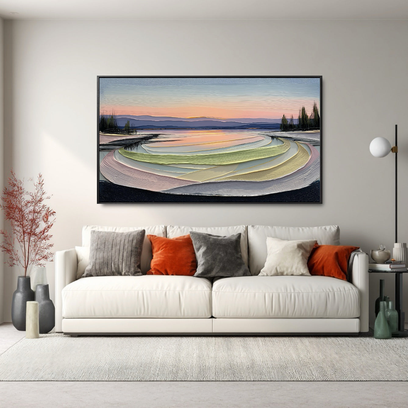 Original highly textured painting adds vibrancy and soft color above a white sofa; accented by orange and gray pillows for a welcoming, modern feel.