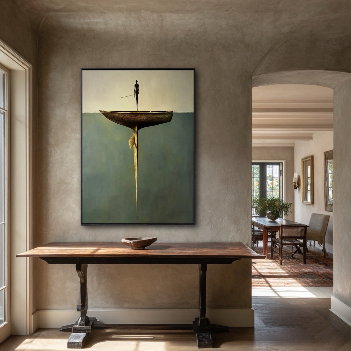 The painting's warm, neutral sky and earthy tones harmonize perfectly with the rustic wood console and textured plaster walls of this entryway.