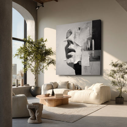 A large abstract face painting in a bright, minimalist living room with a large arched window, plants, and cream furniture.