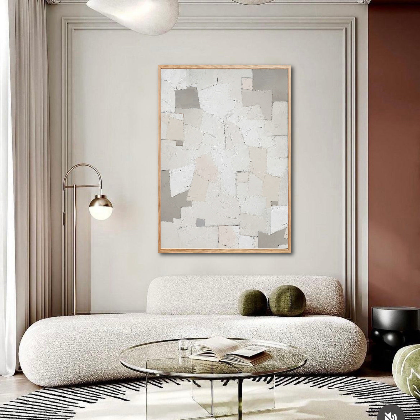 Modern living room with a textured sofa, glass coffee table, and abstract wall art.