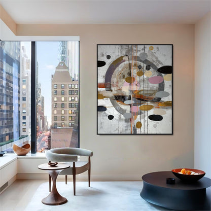 Abstract circular painting over black tables in a minimalist room with panoramic windows showing a busy cityscape.