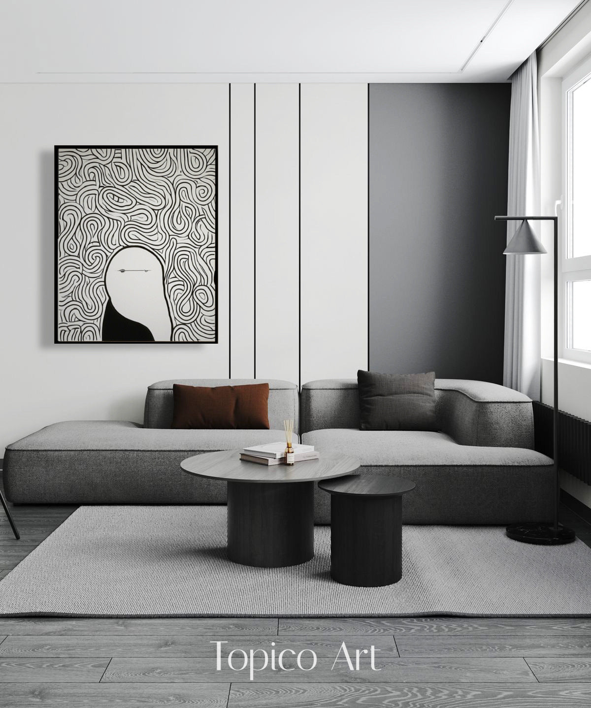 Abstract feline painting above a gray sectional in a minimalist lounge, adding dynamic pattern and stark contrast to the neutral space.