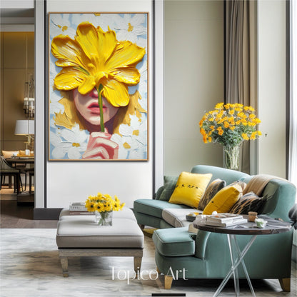 Textured modern art complements a stylish contemporary setting. The yellow flower echoes the throw pillows and fresh florals, creating a cohesive, curated look with the teal sofa.