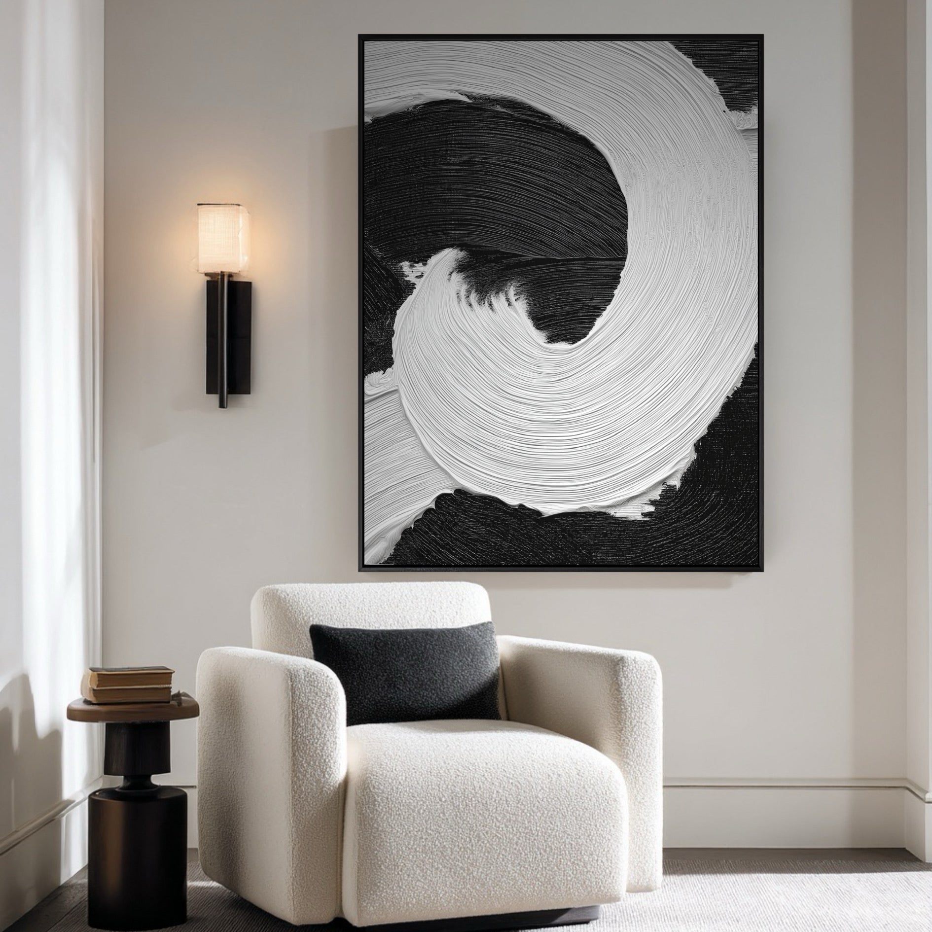 Vertical black and white abstract painting adds contrast to a bright, minimalist room with a white boucle armchair and black pillow.