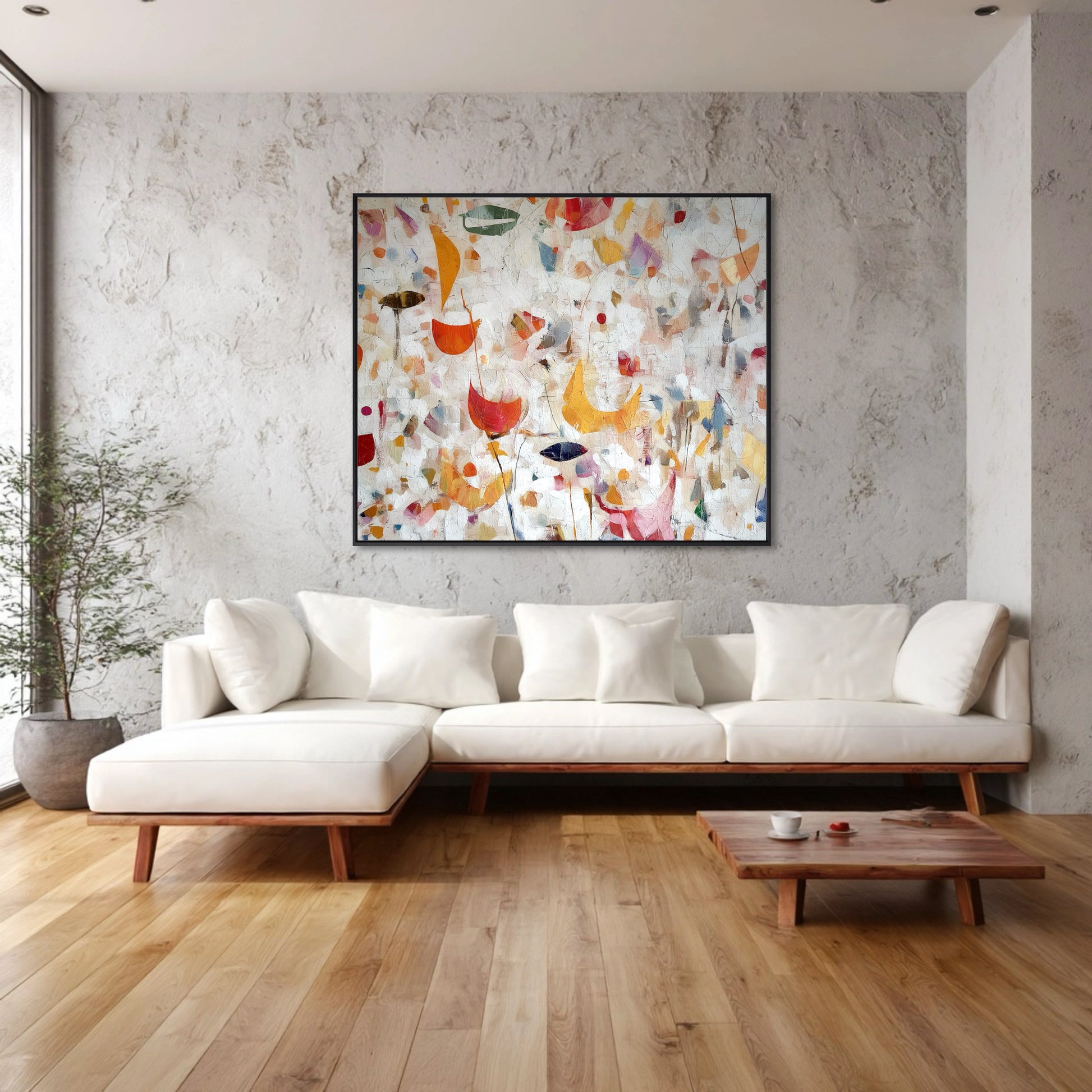 Original Abstract Expressionist painting provides bright, warm color to a clean, minimalist room with white seating and textured concrete walls.
