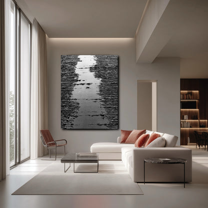 Bold art over white sofa, setting a modern open-concept tone. The neutral wall offsets warm red accents for contrast.