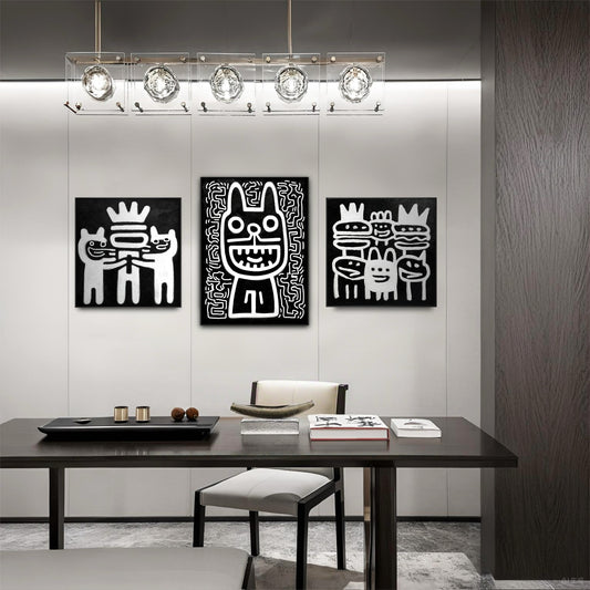 Black and white pop art triptych above a sleek dark wood table and minimalist white chairs in a sophisticated dining or conference room.