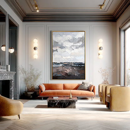 Abstract landscape anchors a classic room with molding, a marble fireplace, and an orange velvet warm sofa.
