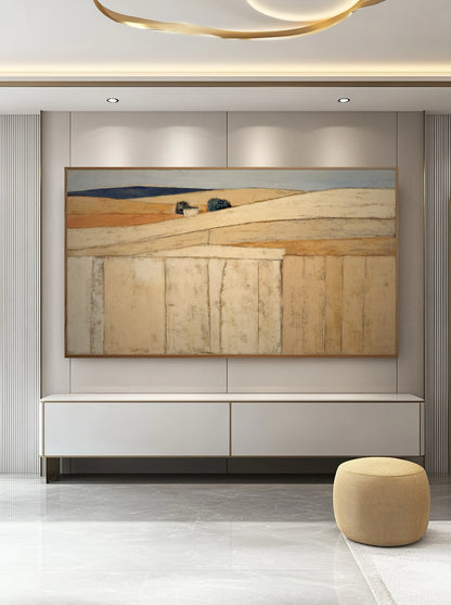 Minimalist abstract art maintains the quiet, cool-toned atmosphere of the hallway with white wall paneling and simple wood console.
