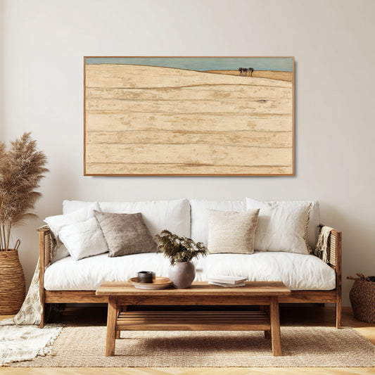 Textured original art integrates seamlessly with the woven rattan, wood furniture, and soft textiles, fostering a quiet, organic mood.