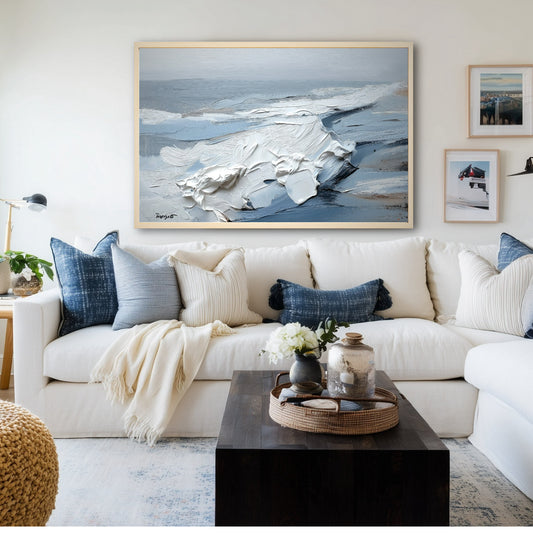 A large, textured abstract painting serves as a sophisticated focal point in a modern living room with a white sofa and blue accents.