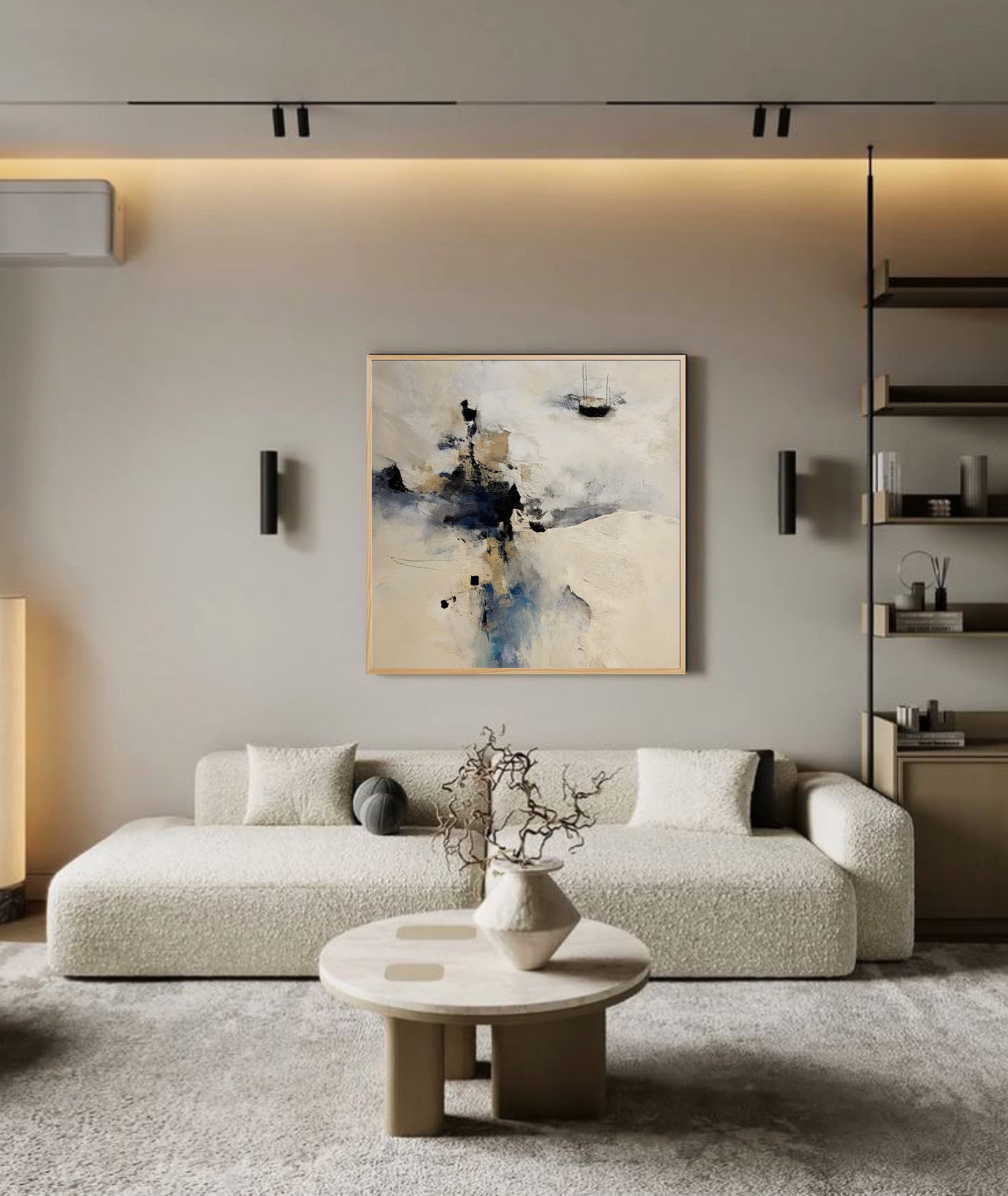 Misty abstract artwork adds depth to a minimalist, Scandinavian-style lounge; its light neutral tones harmonize with the beige textured sofa and streamlined built-ins.