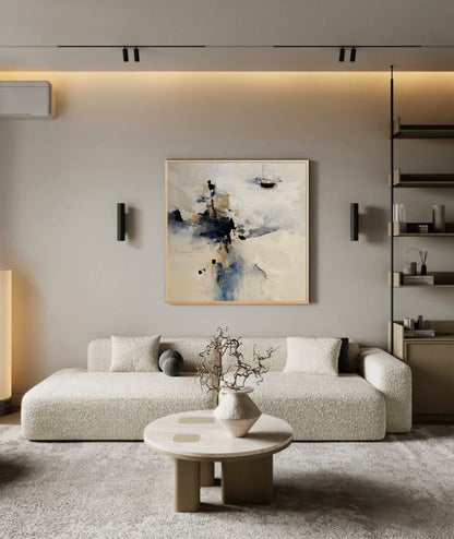 Misty abstract artwork adds depth to a minimalist, Scandinavian-style lounge; its light neutral tones harmonize with the beige textured sofa and streamlined built-ins.