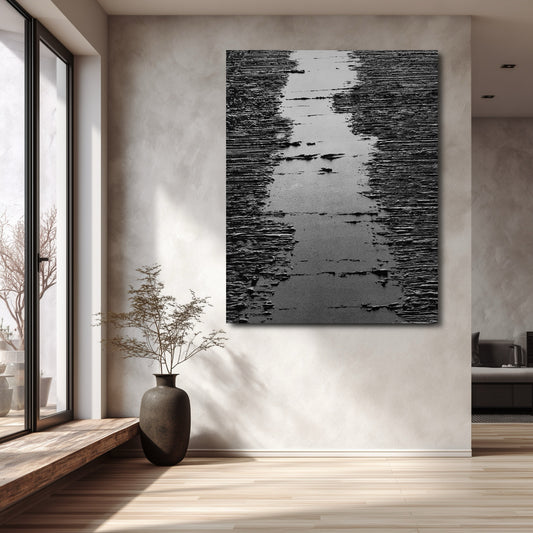 Original art on textured wall, enhancing minimalist, sunlit interior with high window and dark vase. Strong vertical impact.