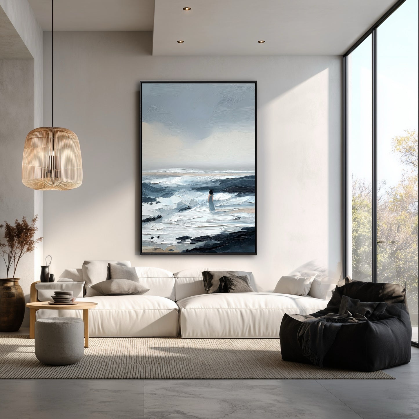 The large figurative painting adds a contemplative, atmospheric mood to this bright, modern minimalist room with a white sectional.