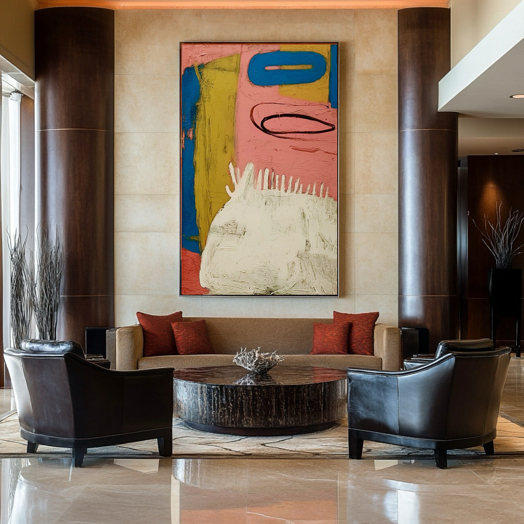 Bold abstract art adds color above a sofa in a sophisticated lobby with dark wood columns, leather armchairs, and polished marble floors.