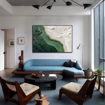 Bold green and white impasto art over a striking blue mid-century sofa, creating a high-contrast focal point in an artistic modern space.