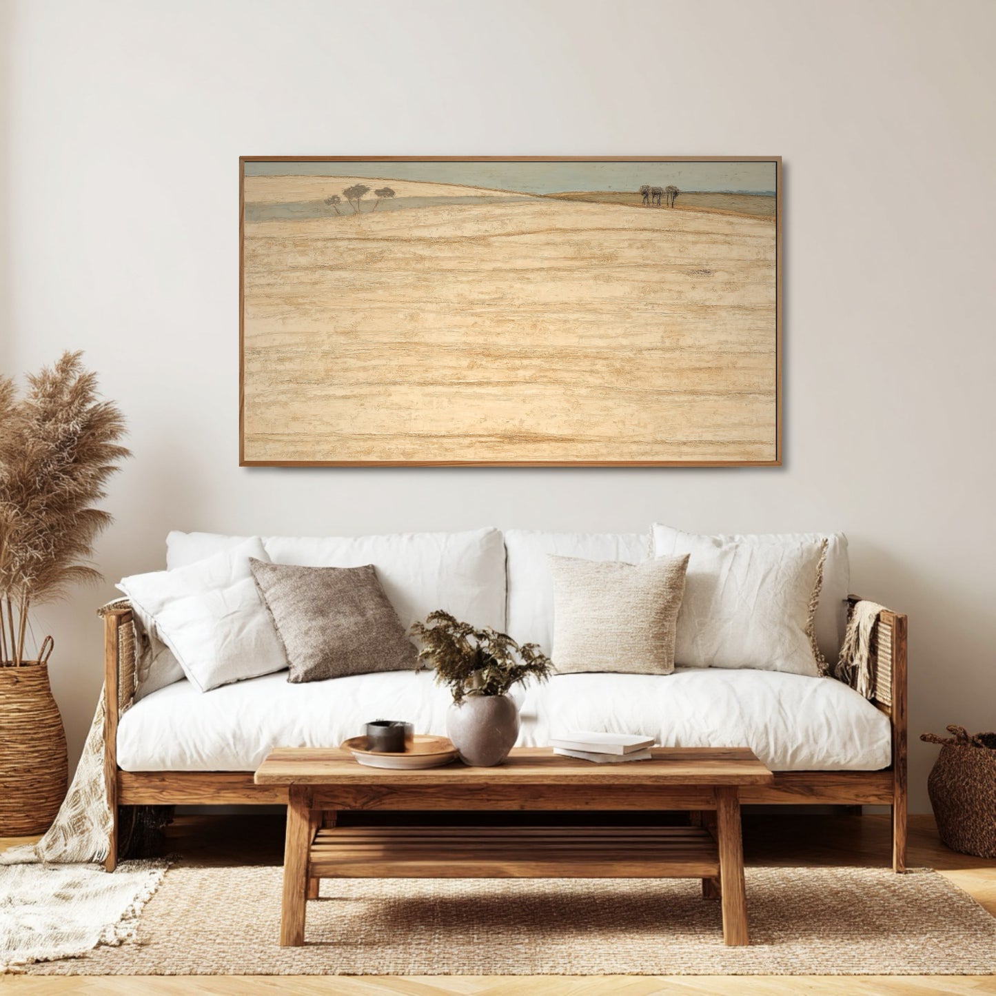 Textured original art amplifies the rich, natural textures of rattan, woven baskets, and linen in this serene Bohemian living space.