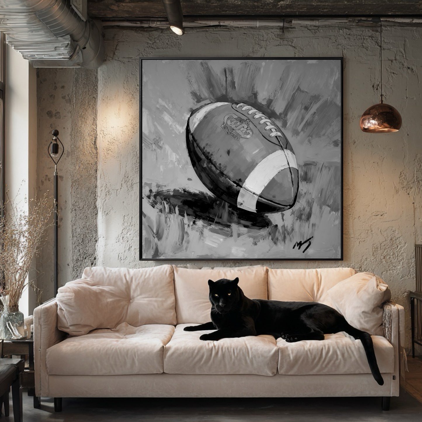 Large black and white painting of a football in an industrial loft with a pink sofa. A black panther is lying on the sofa.