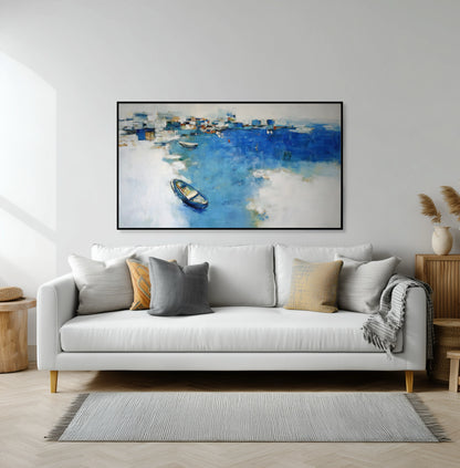 Tranquil coastal art creating a serene escape above a white sectional, enhancing the light, open vibe of the neutral living room.