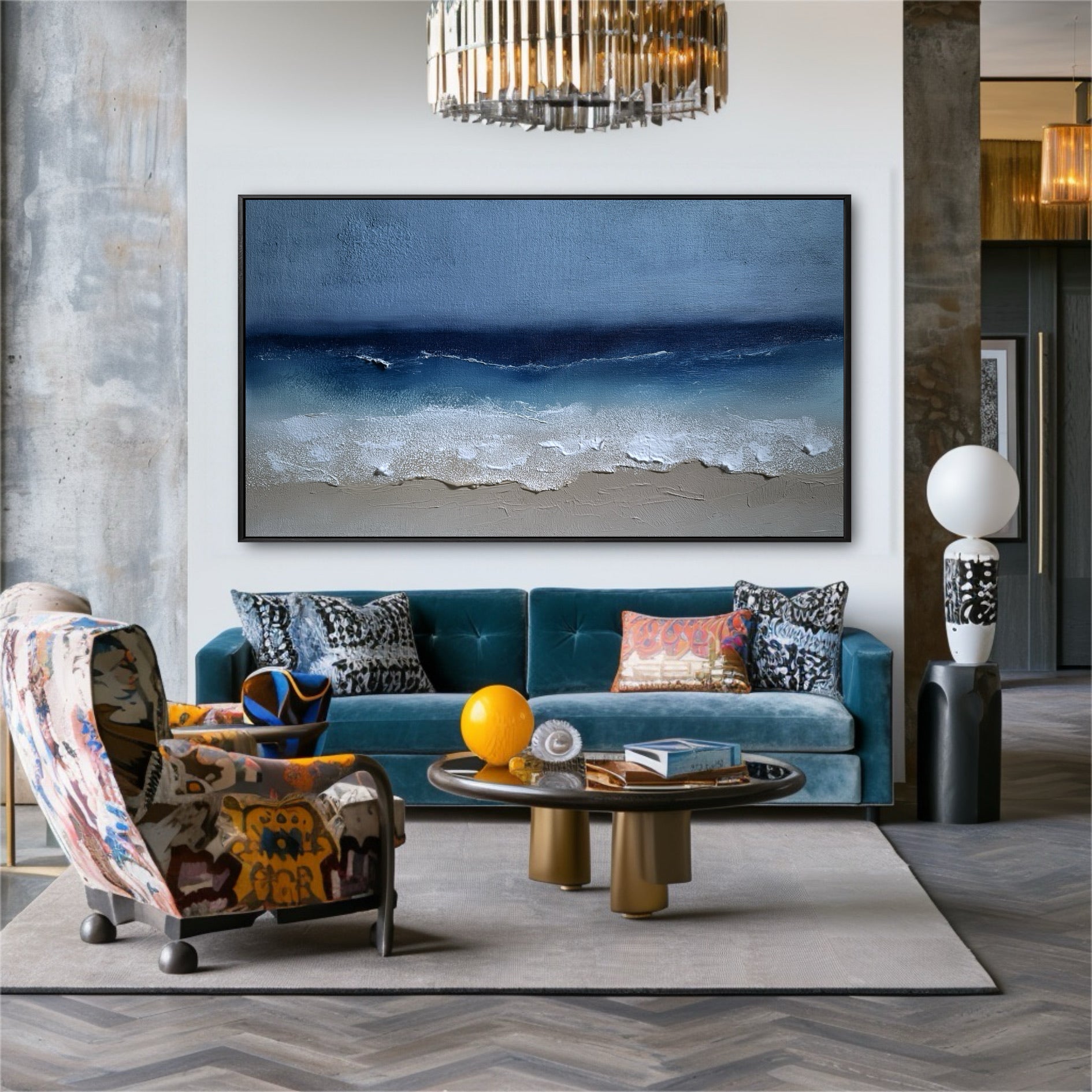 The large beach painting acts as a serene anchor in a bold, eclectic room, its blue hues complementing the velvet sofa and patterned chair.