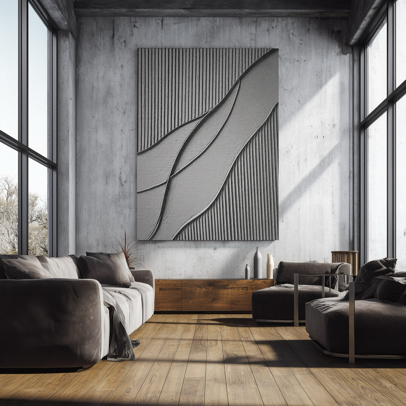 Textured grey art above a dark sofa and armchair on a warm herringbone floor, set in a comfortable, modern living space.