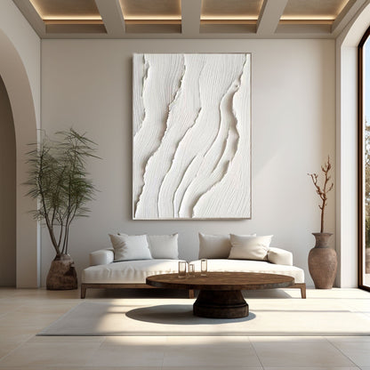  Textured neutral art central to an open space with a coffered wood ceiling and natural light, balancing modern and organic elements.