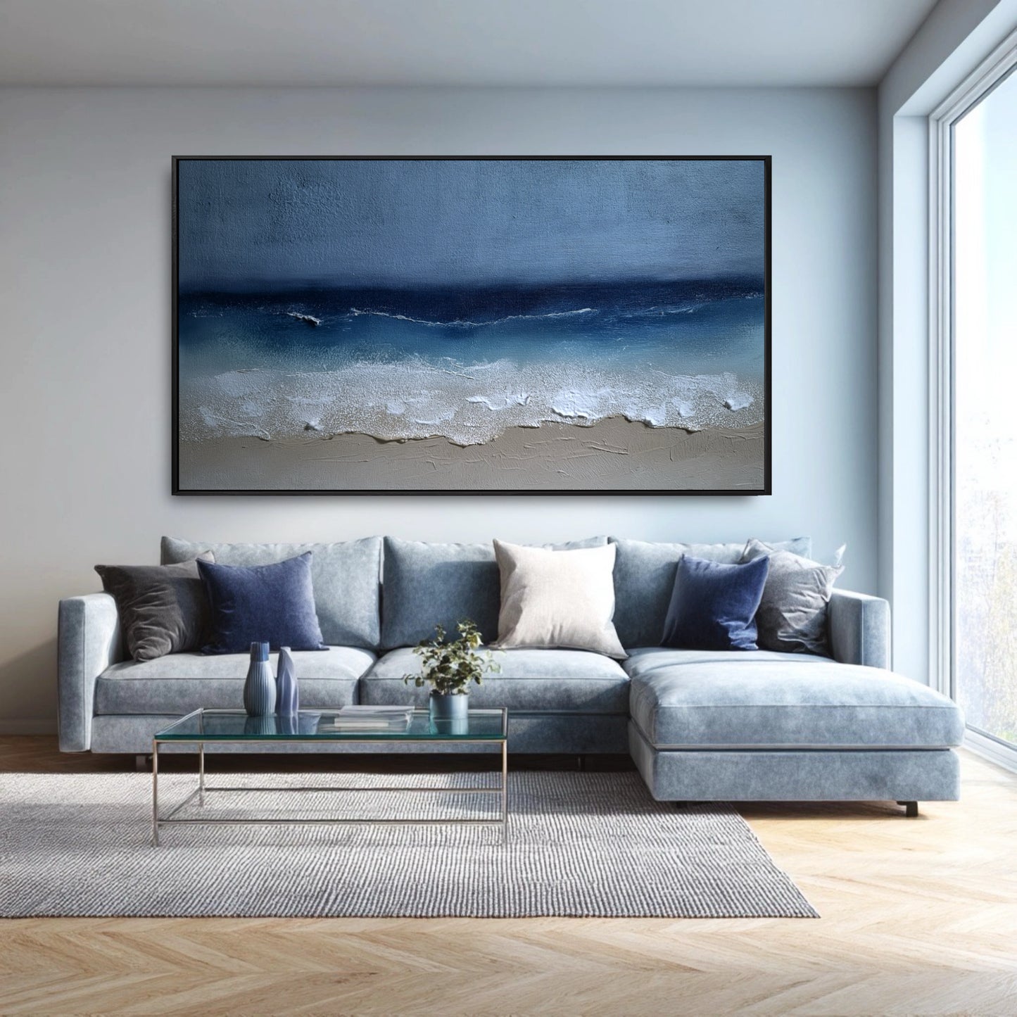 The large seascape painting's blue tones create a cohesive, monochromatic look with the light blue sectional in this modern, bright room.