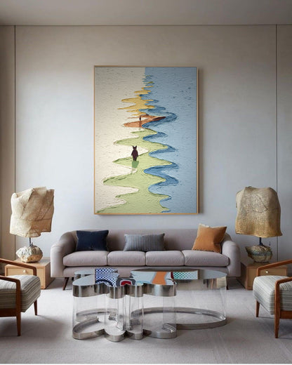 Modern living room with a gray sofa, abstract painting, and decorative lamps.